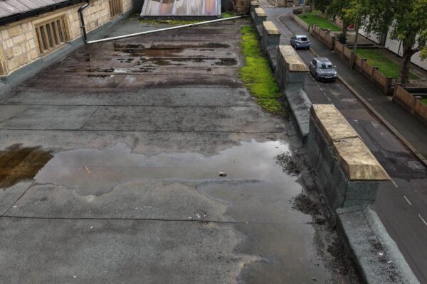 St Mary’s Church Halifax – lifted roof felt Close aerial view of lifted and weathered felt at a flat roof section of St Mary’s Church, Halifax.
